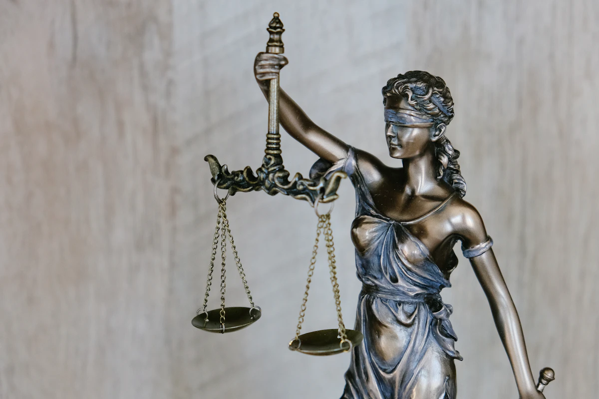 Scales of justice statue representing legal practice and case management